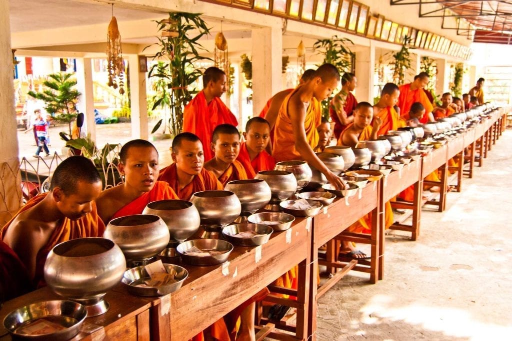 Buddhist monks at Pchum Ben await offerings of food and money
